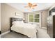 Cozy bedroom with soft lighting, a ceiling fan, and a large window at 7833 Meadow Bend Dr, Indianapolis, IN 46259