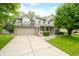 Two story home featuring a two car garage, green lawn, mature landscaping, and inviting porch at 7833 Meadow Bend Dr, Indianapolis, IN 46259