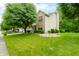 Two story home featuring a green lawn, mature landscaping, and inviting porch at 7833 Meadow Bend Dr, Indianapolis, IN 46259