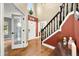 Light and bright foyer with views to other rooms, staircase, and hardwood flooring at 7833 Meadow Bend Dr, Indianapolis, IN 46259