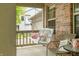 Cozy porch swing with decorative pillows on a brick home's charming front porch at 7833 Meadow Bend Dr, Indianapolis, IN 46259