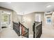 Upstairs hallway featuring a staircase, chandelier, and views into the bedrooms, creating an airy, bright, and elegant space at 7833 Meadow Bend Dr, Indianapolis, IN 46259