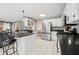 Stylish kitchen with black countertops, stainless steel appliances, and views to the living area at 7833 Meadow Bend Dr, Indianapolis, IN 46259