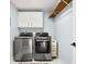 Bright laundry room featuring modern washer and dryer, white cabinets, and wooden hanging rack at 7833 Meadow Bend Dr, Indianapolis, IN 46259