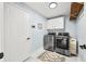 Well-lit laundry room with updated, stainless steel washer and dryer and modern tile flooring at 7833 Meadow Bend Dr, Indianapolis, IN 46259