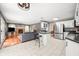 Open-concept living area with hardwood floors, brick fireplace, and seamless flow into the kitchen at 7833 Meadow Bend Dr, Indianapolis, IN 46259