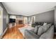 Comfortable living room with a brick fireplace, hardwood floors, and neutral-toned furniture at 7833 Meadow Bend Dr, Indianapolis, IN 46259