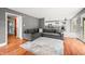 Comfortable living room with gray sectional sofa, area rug, and views into the kitchen at 7833 Meadow Bend Dr, Indianapolis, IN 46259