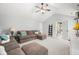 Living room features high ceilings, modern fan, and comfortable seating with a view of hall at 7833 Meadow Bend Dr, Indianapolis, IN 46259