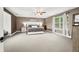 Spacious bedroom featuring large windows, ceiling fan, and neutral colored carpet at 7833 Meadow Bend Dr, Indianapolis, IN 46259