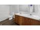 Bathroom with wood cabinets, double sinks, and a shower-tub at 7854 Wolfgang Pl, Indianapolis, IN 46239