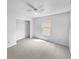 This carpeted bedroom features a ceiling fan, window, and a closet with ample storage space at 7854 Wolfgang Pl, Indianapolis, IN 46239