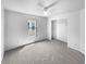 Bright bedroom features neutral carpet, a ceiling fan, and a window with natural light at 7854 Wolfgang Pl, Indianapolis, IN 46239