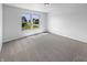 This spacious carpeted bedroom features two windows that provide a view to the neighborhood at 7854 Wolfgang Pl, Indianapolis, IN 46239