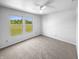 This is a carpeted bedroom with a ceiling fan and a scenic view from the window at 7854 Wolfgang Pl, Indianapolis, IN 46239