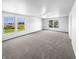 Spacious bedroom with a ceiling fan and large windows showcasing landscape views at 7854 Wolfgang Pl, Indianapolis, IN 46239