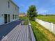 View of a wooden deck overlooking a grassy field and fenced yard, perfect for outdoor enjoyment at 7854 Wolfgang Pl, Indianapolis, IN 46239
