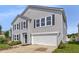 Charming two-story home with gray siding, black shutters, and a two-car garage, enhancing curb appeal at 7854 Wolfgang Pl, Indianapolis, IN 46239