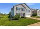 Two-story home with a gray exterior, complemented by lush green lawn and well-maintained landscaping at 7854 Wolfgang Pl, Indianapolis, IN 46239