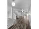 Bright hallway featuring hardwood floors, a staircase, and views to other rooms at 7854 Wolfgang Pl, Indianapolis, IN 46239