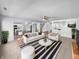Bright living room with modern furnishings, neutral tones, and a view into the kitchen at 7854 Wolfgang Pl, Indianapolis, IN 46239