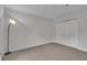 Cozy carpeted bedroom with minimalist decor, a standing lamp and closet at 8176 Shorewalk Dr # C, Indianapolis, IN 46236