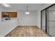Bright dining area with wood floors, modern lighting, and a sliding glass door to a balcony at 8176 Shorewalk Dr # C, Indianapolis, IN 46236