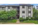 Inviting condo exterior with well-maintained landscaping and a charming, multi-level entryway at 8176 Shorewalk Dr # C, Indianapolis, IN 46236
