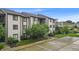 Condo exterior featuring ample parking, mature landscaping, and a well-maintained facade at 8176 Shorewalk Dr # C, Indianapolis, IN 46236
