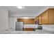 Well-lit kitchen features marble countertops, stainless steel appliances and wood cabinets at 8176 Shorewalk Dr # C, Indianapolis, IN 46236