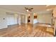 Spacious living room with wood flooring, fireplace, ceiling fan, and access to the kitchen at 8176 Shorewalk Dr # C, Indianapolis, IN 46236