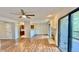 Spacious living room with wood flooring, fireplace, ceiling fan, and access to the kitchen at 8176 Shorewalk Dr # C, Indianapolis, IN 46236