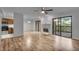 Bright living room with wood floors, fireplace, modern fan, and sliding glass door leading to balcony at 8176 Shorewalk Dr # C, Indianapolis, IN 46236