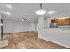 Open concept living and dining area with wood floors, modern lighting, and an adjacent kitchen at 8176 Shorewalk Dr # C, Indianapolis, IN 46236
