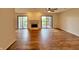 Bright living room with wood floors, fireplace, and sliding glass doors to a balcony at 8176 Shorewalk Dr # C, Indianapolis, IN 46236