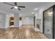 Open concept living room with wood floors, fireplace, and sliding doors leading to a balcony at 8176 Shorewalk Dr # C, Indianapolis, IN 46236