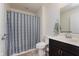 Cozy bathroom with modern vanity, toilet, and shower with patterned curtain at 985 Farmington Trl, Brownsburg, IN 46112