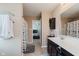 Well-lit bathroom with a large mirror, vanity, and shower with a leafy curtain at 985 Farmington Trl, Brownsburg, IN 46112