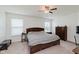 Spacious bedroom featuring a ceiling fan, carpet flooring, and two windows at 985 Farmington Trl, Brownsburg, IN 46112