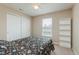 Comfortable bedroom featuring a bed with floral bedding, a ceiling fan, and ample natural light at 985 Farmington Trl, Brownsburg, IN 46112