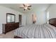 Bright bedroom with a ceiling fan and a wooden dresser, offering ample storage at 985 Farmington Trl, Brownsburg, IN 46112