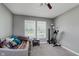 Cozy bedroom showcasing a comfortable daybed, soft carpeting, and plenty of natural light from the two bright windows at 985 Farmington Trl, Brownsburg, IN 46112