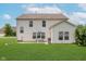 Exterior of a two-story home showcasing the spacious backyard with a patio and firepit at 985 Farmington Trl, Brownsburg, IN 46112