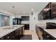 Spacious kitchen with stainless steel appliances, ample counter space, and modern dark cabinetry for a functional design at 985 Farmington Trl, Brownsburg, IN 46112