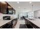 Well-appointed kitchen featuring dark cabinets, and an island perfect for cooking and entertaining with an adjacent dining area at 985 Farmington Trl, Brownsburg, IN 46112