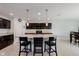 Stylish kitchen featuring dark cabinets, an island with seating, and ample counter space for culinary creations and casual dining at 985 Farmington Trl, Brownsburg, IN 46112