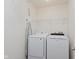Laundry area with a side-by-side washer and dryer and wire shelving for extra storage at 985 Farmington Trl, Brownsburg, IN 46112