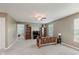 Spacious living room with carpet, natural light, ceiling fan, and wooden futon at 985 Farmington Trl, Brownsburg, IN 46112