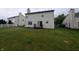 Large backyard featuring a lush lawn, an exterior patio, and an attached back door at 10150 Beresford Ct, Fishers, IN 46038