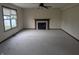 Bright living room featuring a fireplace, neutral carpet, large windows, and ceiling fan at 10150 Beresford Ct, Fishers, IN 46038